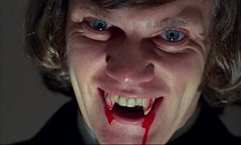 Movie still from “A Clockwork Orange” (1971), directed by Stanley Kubrick – A man's face with blood dripping from his mouth; Close Up shot, Overhead angle