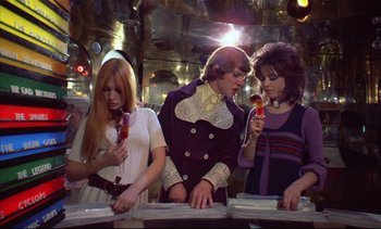 Movie still from “A Clockwork Orange” (1971), directed by Stanley Kubrick – A group of people standing next to each other in a room; Medium shot, High angle