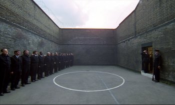 Movie still from “A Clockwork Orange” (1971), directed by Stanley Kubrick – A group of people standing in front of a wall; Extreme Wide shot, High angle