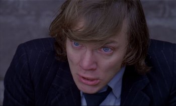 Movie still from “A Clockwork Orange” (1971), directed by Stanley Kubrick – A person wearing a suit and tie; Close Up shot, Low angle