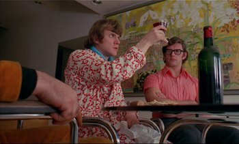 Movie still from “A Clockwork Orange” (1971), directed by Stanley Kubrick – Two men sitting at a table drinking beer; Medium shot, Low angle