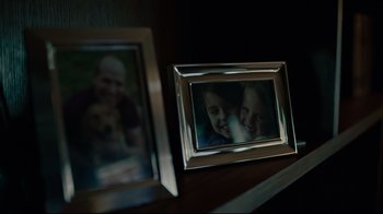 A picture of two people and a dog in front of a mirror