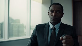 Movie still from “A Cure for Wellness” (2016), directed by Gore Verbinski – A man wearing a suit and tie in front of a window; Close Up shot, Over the shoulder angle