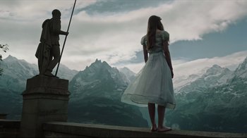 Movie still from “A Cure for Wellness” (2016), directed by Gore Verbinski – A woman in a white dress looking at a mountain; Wide shot, Low angle
