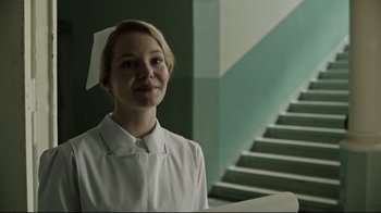 Movie still from “A Cure for Wellness” (2016), directed by Gore Verbinski – A woman wearing a white shirt and a white hat; Medium shot, Low angle