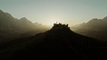 Movie still from “A Cure for Wellness” (2016), directed by Gore Verbinski – The sun is setting over a castle on top of a hill; Extreme Wide shot, Low angle