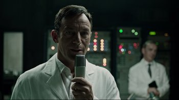 Movie still from “A Cure for Wellness” (2016), directed by Gore Verbinski – A man in a white lab coat holding a cell phone; Close Up shot, Over the shoulder angle