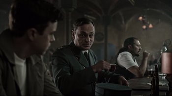 Movie still from “A Cure for Wellness” (2016), directed by Gore Verbinski – A man in a military uniform is holding a hat; Medium shot, Over the shoulder angle