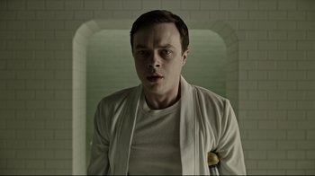 Movie still from “A Cure for Wellness” (2016), directed by Gore Verbinski – A man in white shirt and white jacket looking at the camera; Close Up shot, Low angle