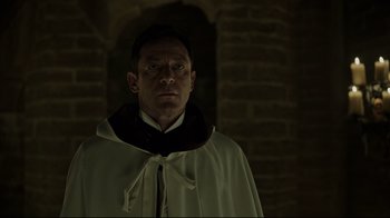 Movie still from “A Cure for Wellness” (2016), directed by Gore Verbinski – A man wearing a white robe and a black collar; Close Up shot, Over the shoulder angle