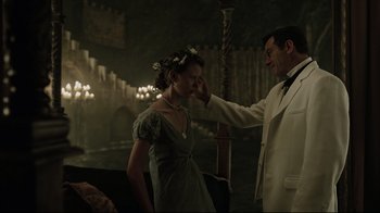 Movie still from “A Cure for Wellness” (2016), directed by Gore Verbinski – A man touching a woman's face in a dark room; Medium shot, Low angle