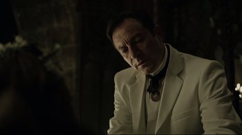 Movie still from “A Cure for Wellness” (2016), directed by Gore Verbinski – A man in a white suit and a black tie; Close Up shot, Over the shoulder angle