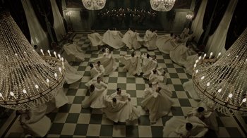 Movie still from “A Cure for Wellness” (2016), directed by Gore Verbinski – A group of men in white robes dancing on a checkerboard floor; Extreme Wide shot, Overhead angle