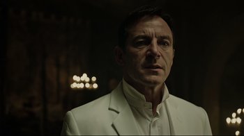 Movie still from “A Cure for Wellness” (2016), directed by Gore Verbinski – A man wearing a white suit and a white shirt; Close Up shot, Over the shoulder angle