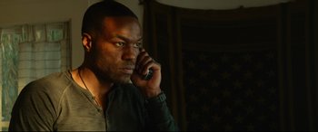 Movie still from “Ambulance” (2022), directed by Michael Bay – A man is talking on a cell phone; Close Up shot, Low angle