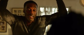 Movie still from “Ambulance” (2022), directed by Michael Bay – A person with his hand raised up; Close Up shot, Over the shoulder angle