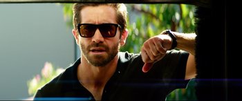 Movie still from “Ambulance” (2022), directed by Michael Bay – A person wearing sunglasses; Close Up shot, Over the shoulder angle