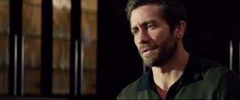 Movie still from “Ambulance” (2022), directed by Michael Bay – A person with a beard looking to his left; Close Up shot, Over the shoulder angle