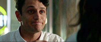 Movie still from “Ambulance” (2022), directed by Michael Bay – A person sitting in front of a window; Close Up shot, Over the shoulder angle