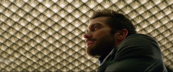 Movie still from “Ambulance” (2022), directed by Michael Bay – A man with a goatee looking up at the ceiling; Close Up shot, Low angle