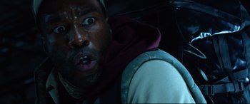 Movie still from “Ambulance” (2022), directed by Michael Bay – A person in a car with his mouth wide open; Close Up shot, Low angle