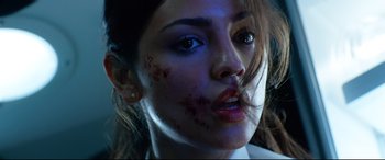 Movie still from “Ambulance” (2022), directed by Michael Bay – A person with blood all over her face; Close Up shot, Low angle