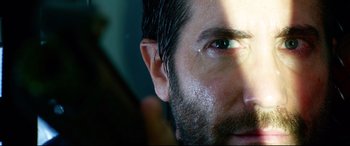 Movie still from “Ambulance” (2022), directed by Michael Bay – A man's face with water on his face; Extreme Close Up shot, Low angle