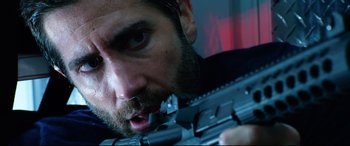 Movie still from “Ambulance” (2022), directed by Michael Bay – A person holding a gun; Close Up shot, Low angle