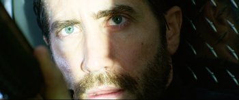 Movie still from “Ambulance” (2022), directed by Michael Bay – A man's face with green eyes; Extreme Close Up shot, Low angle