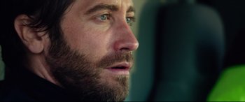 Movie still from “Ambulance” (2022), directed by Michael Bay – A man with a beard looking to his left; Close Up shot, Over the shoulder angle