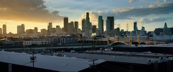 Movie still from “Ambulance” (2022), directed by Michael Bay – A view of a city skyline at sunset; Extreme Wide shot, High angle