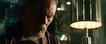 Movie still from “Ambulance” (2022), directed by Michael Bay – An older man looking down at his face in front of a mirror; Close Up shot, Low angle