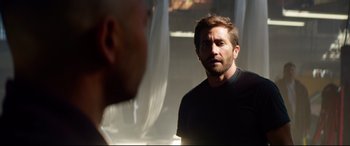 Movie still from “Ambulance” (2022), directed by Michael Bay – A man standing in front of a bathroom mirror; Medium shot, Over the shoulder angle