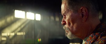 Movie still from “Ambulance” (2022), directed by Michael Bay – An older man with a beard is looking into the distance; Close Up shot, Low angle