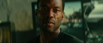 Movie still from “Ambulance” (2022), directed by Michael Bay – A man's face in front of a blurry background; Close Up shot, Low angle