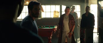 Movie still from “Ambulance” (2022), directed by Michael Bay – Two men standing next to each other in a room; Medium shot, Over the shoulder angle