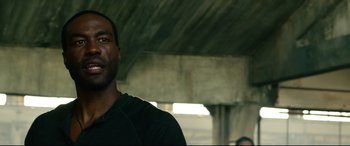 Movie still from “Ambulance” (2022), directed by Michael Bay – A person wearing a black t - shirt; Close Up shot, Low angle