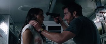 Movie still from “Ambulance” (2022), directed by Michael Bay – A man holding a gun up to a woman's face; Close Up shot, Low angle