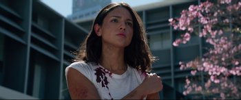 Movie still from “Ambulance” (2022), directed by Michael Bay – A young woman with blood on her arm and shoulder; Close Up shot, Low angle