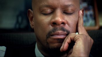 Movie still from “American History X” (1998), directed by Tony Kaye – A person holding his hand to his face; Close Up shot, High angle