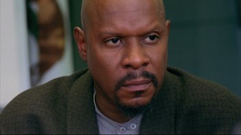 Movie still from “American History X” (1998), directed by Tony Kaye – A man with a beard is looking at the camera; Close Up shot, Over the shoulder angle