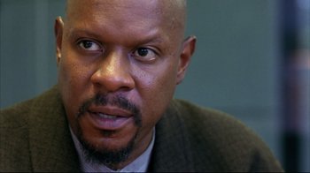 Movie still from “American History X” (1998), directed by Tony Kaye – A person wearing a suit and tie; Close Up shot, Low angle