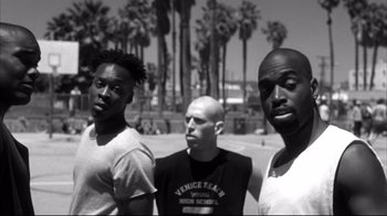 Movie still from “American History X” (1998), directed by Tony Kaye – A group of men standing next to each other near trees; Medium shot, Low angle
