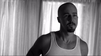 Movie still from “American History X” (1998), directed by Tony Kaye – Black and white photograph of a man with a beard; Close Up shot, Over the shoulder angle