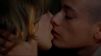 Movie still from “American History X” (1998), directed by Tony Kaye – A young boy and a young girl kissing; Extreme Close Up shot, Low angle