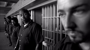 Movie still from “American History X” (1998), directed by Tony Kaye – Two men standing next to each other in front of a jail cell; Medium shot, Low angle