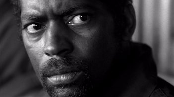 Movie still from “American History X” (1998), directed by Tony Kaye – A man's face in black - and - white; Extreme Close Up shot, Low angle