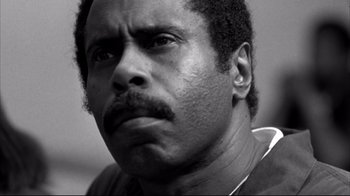 Movie still from “American History X” (1998), directed by Tony Kaye – A black and white photo of a man with a mustache; Close Up shot, Low angle