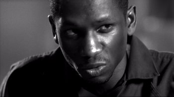 Movie still from “American History X” (1998), directed by Tony Kaye – A black and white photo of a man's face; Close Up shot, Low angle