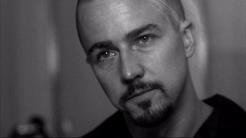 Movie still from “American History X” (1998), directed by Tony Kaye – Black and white photograph of a man with a goatee; Close Up shot, Low angle